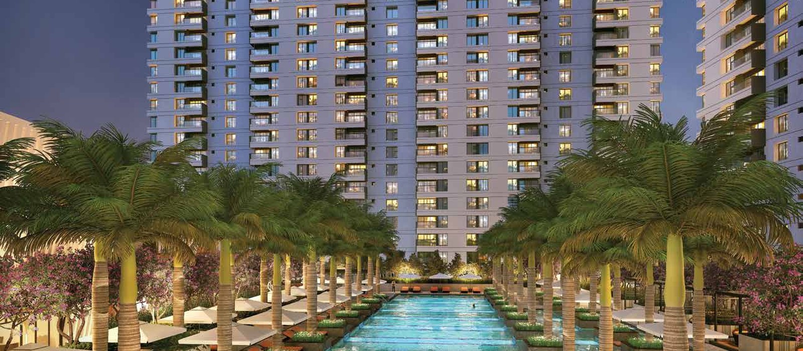 50m Olympic swimming pool and palm-lined pool deck at Kumar Parc Residences
